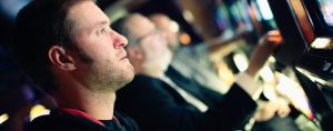 Man at a slot machine.