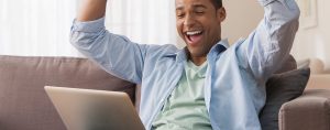 Man cheering at his computer screen.